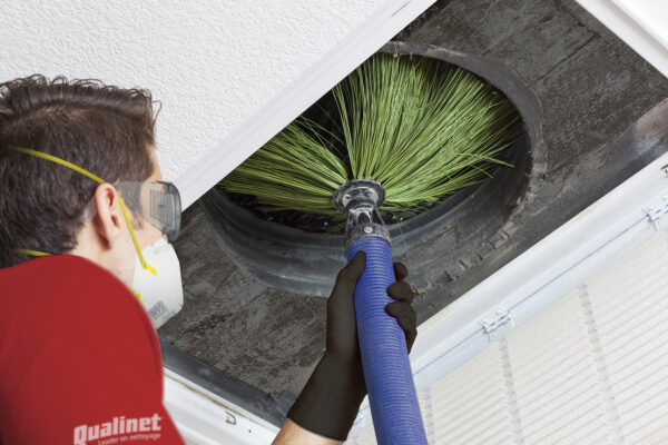 Man cleaning air ducts in home.